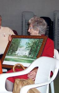 Ophelia Gregory Lyons, the oldest attendee receiving her certificate and a print of Juxa